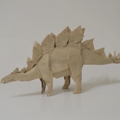 An Origami stegosaurus standing on a white surface, by Shuki Kato